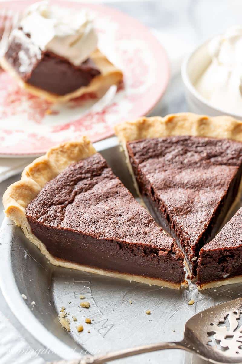 Side view of a pie pan with a few slices left of chocolate chess pie