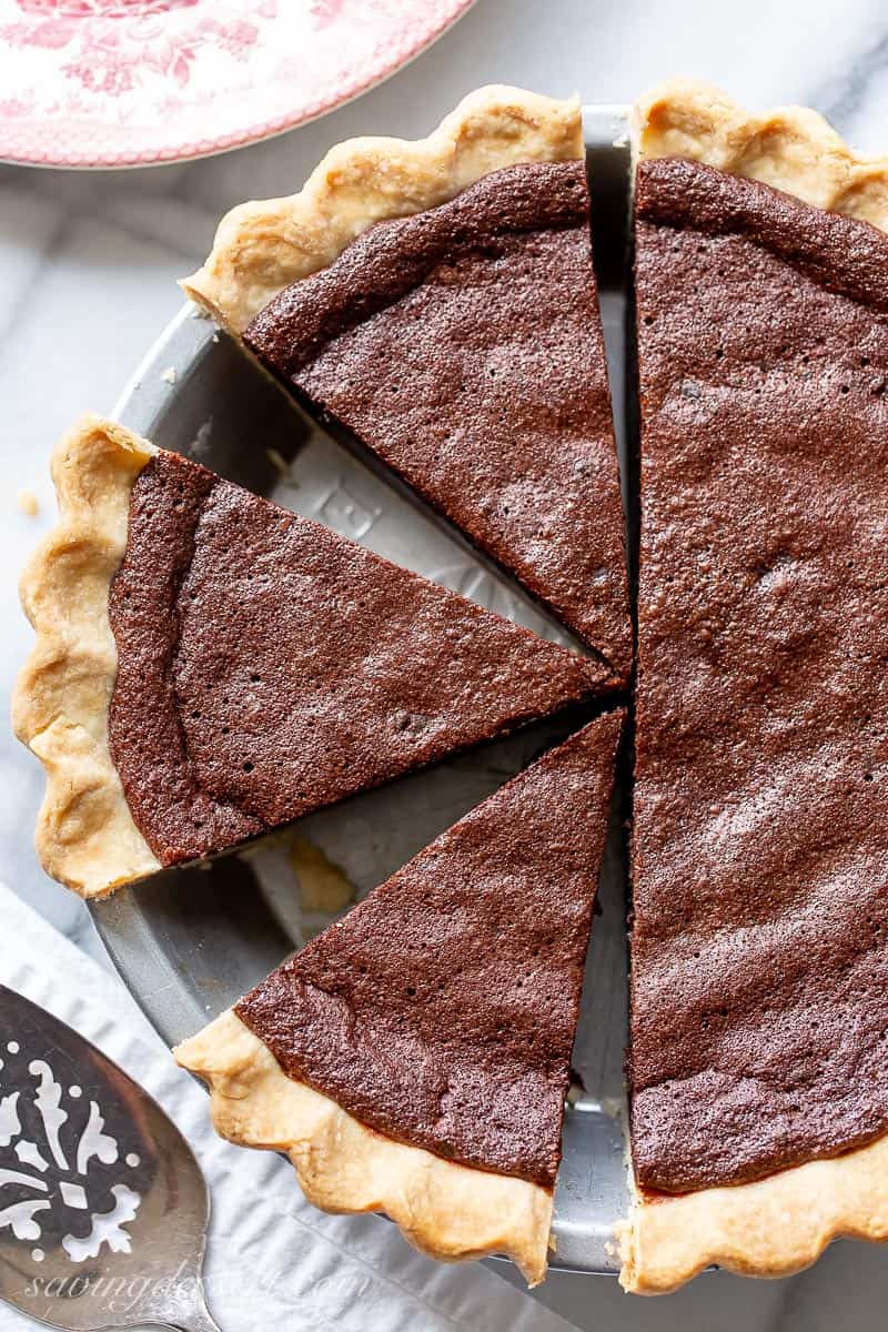 A sliced chocolate chess pie viewed from overhead