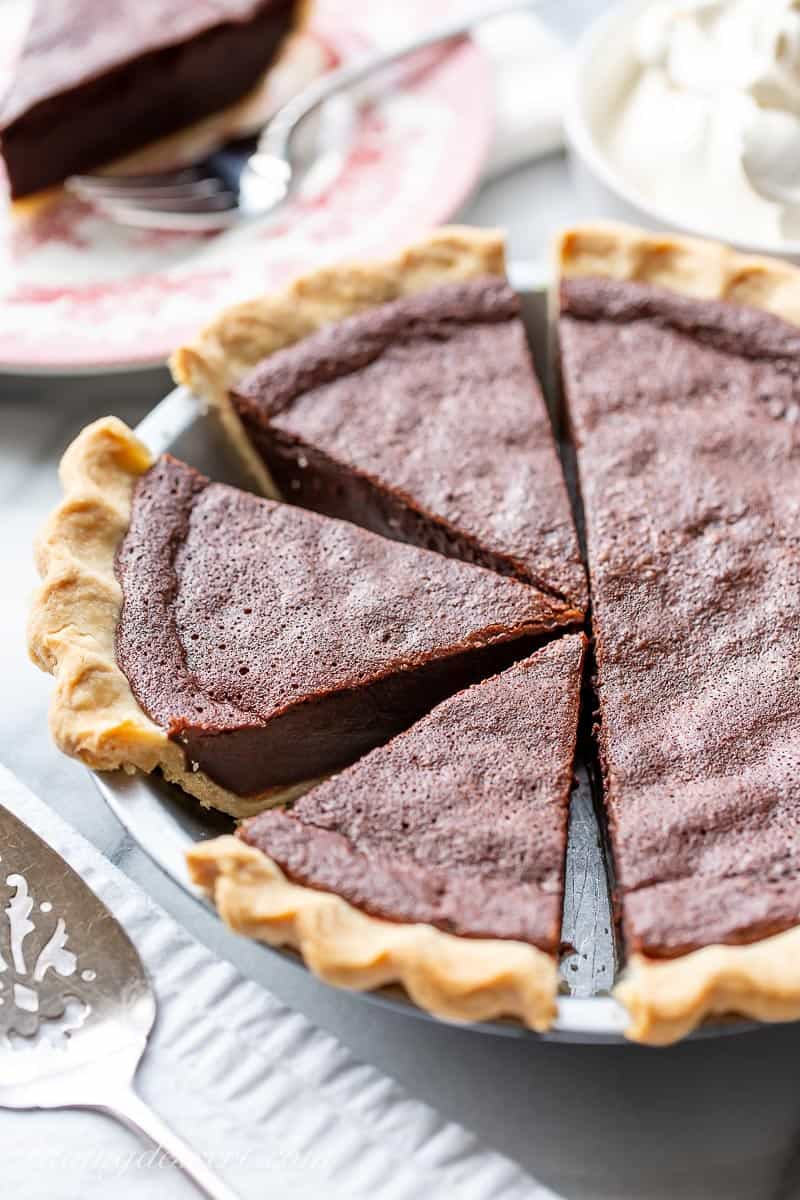 A side view of a sliced chocolate chess pie