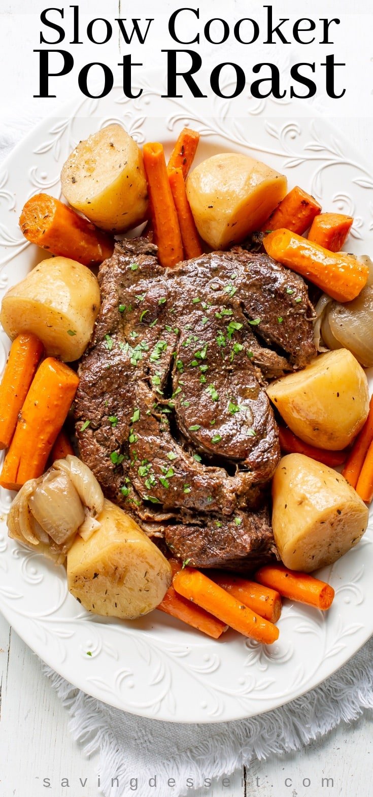 A platter with slow cooker pot roast with potatoes and carrots