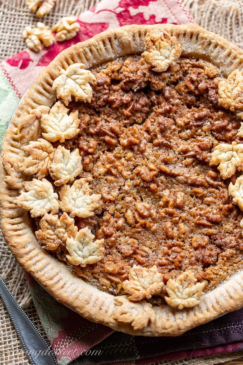 A maple walnut pie decorated with crust cut-outs in the shape of leaves. 