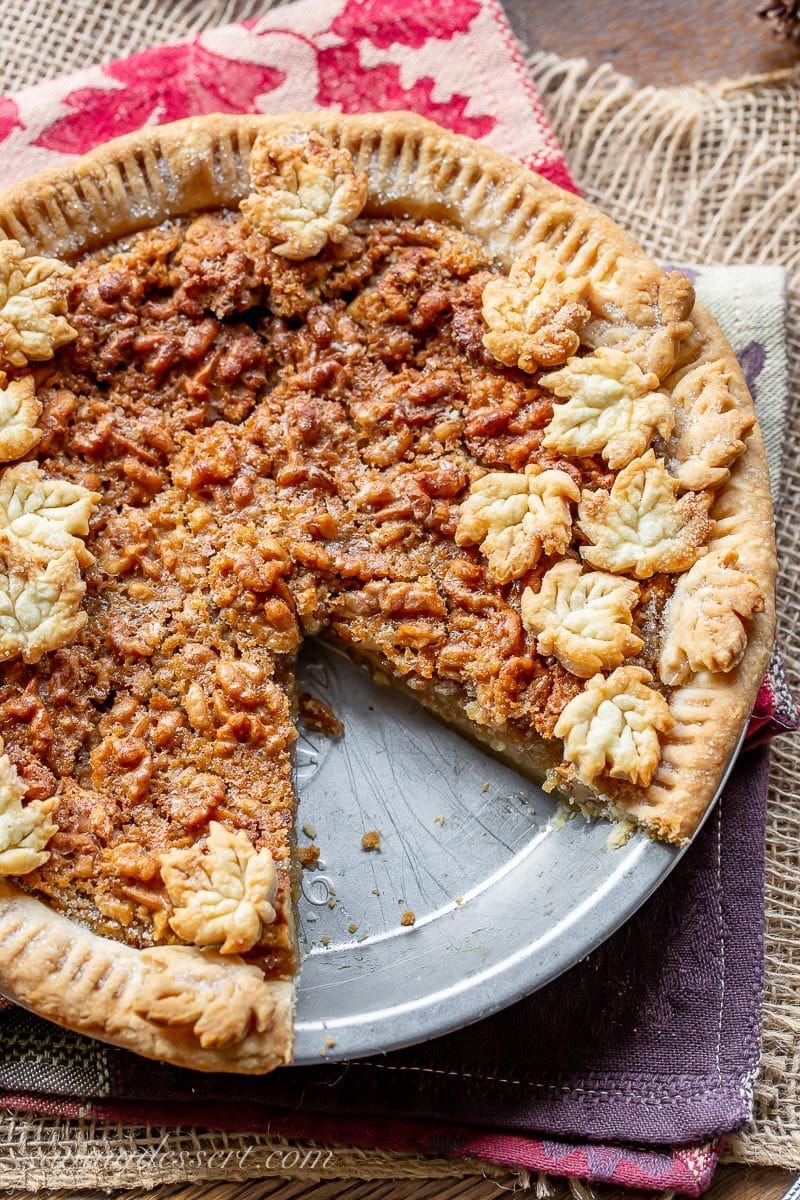 A sliced maple walnut pie with crust cookies on top