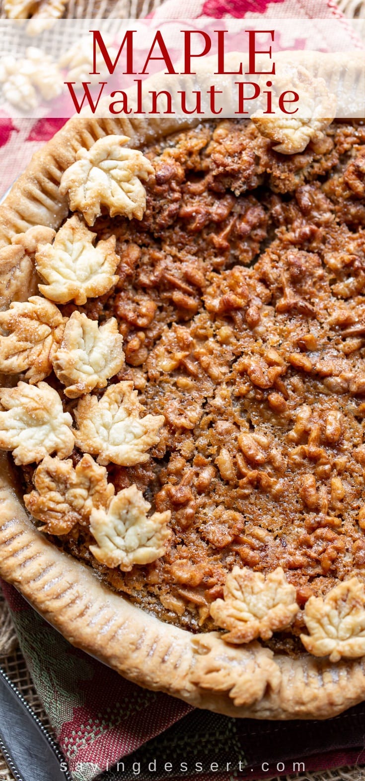 A close up of a maple walnut pie topped with crust cookies in the shape of leaves