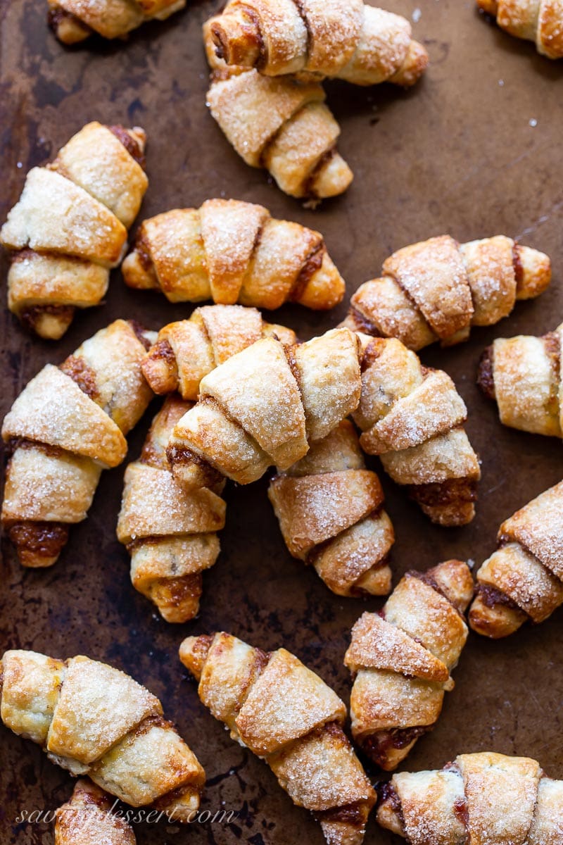 A cookie sheet covered with golden brown Rugelach cookies