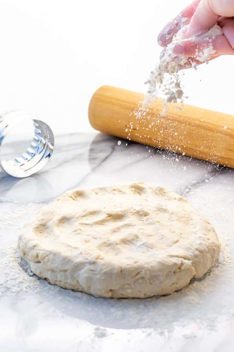 Bread dough being dusted with flour