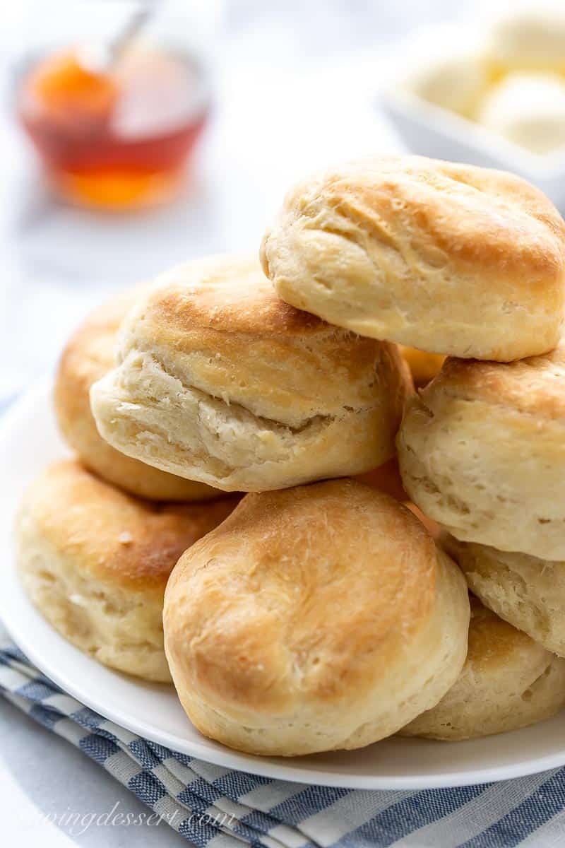 A close up of a stack of angel biscuits on a plate