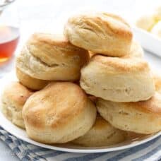 A plate of angel biscuits with butter and honey