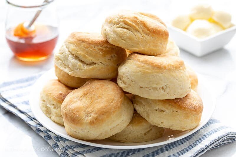 A plate of angel biscuits with butter and honey
