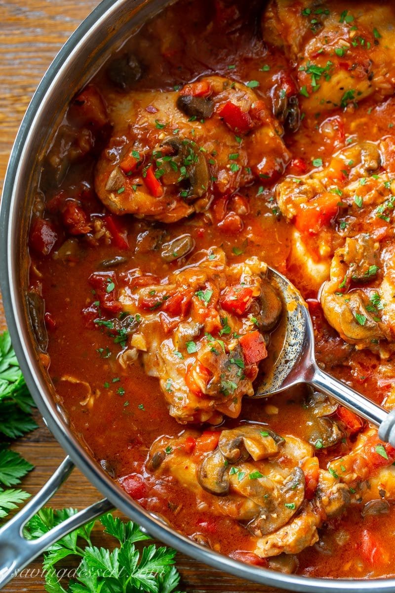 A large skillet filled with Chicken Cacciatore with peppers, onions and mushrooms