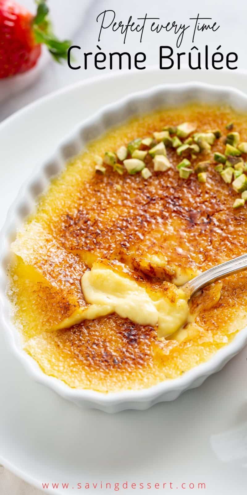 Closeup of crème brûlée with a spoon and broken sugar crust