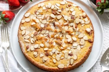 overhead view of an almond cake served with strawberries