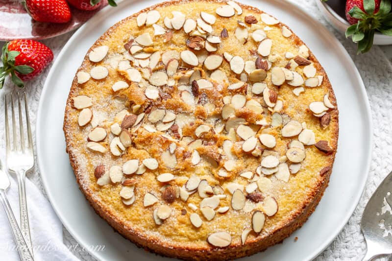 overhead view of an almond cake served with strawberries