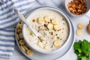 Overhead view of a bowl of creamy New England style Clam Chowder served with oyster crackers
