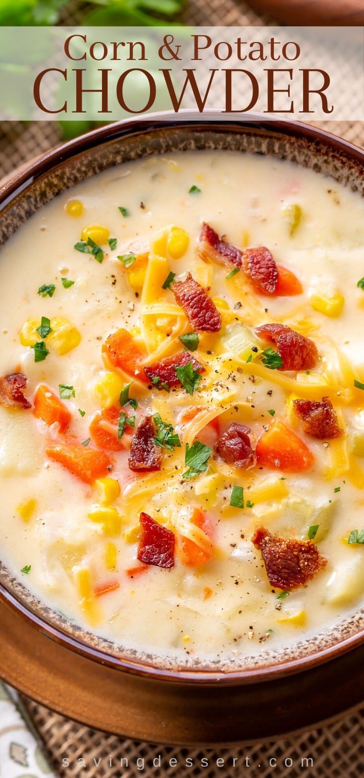 A bowl of hearty Corn & Potato Chowder garnished with bacon, cheese and parsley