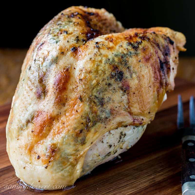 A whole roasted turkey bread on a cutting board