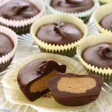 Overhead view of Chocolate Peanut Butter Cups in wrappers on a plate.