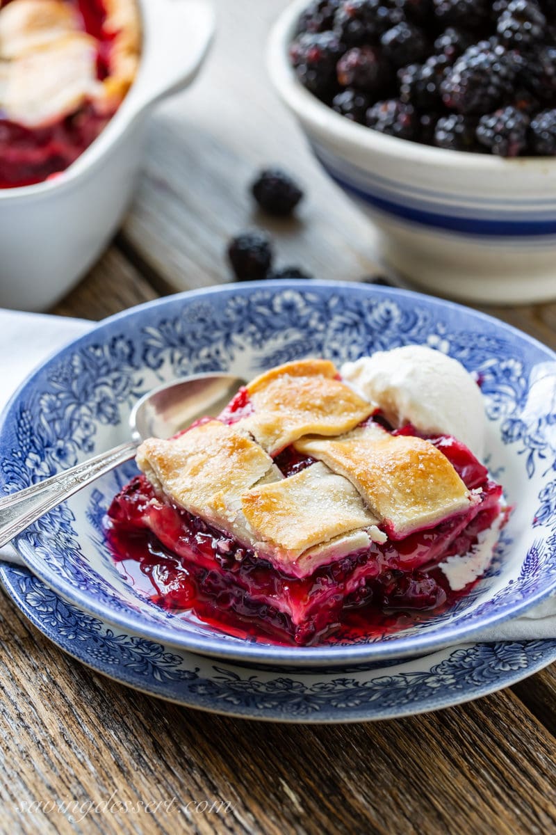 Blackberry cobbler with a lattice top and vanilla ice cream