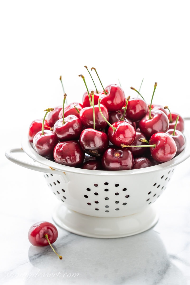 A strainer of fresh cherries
