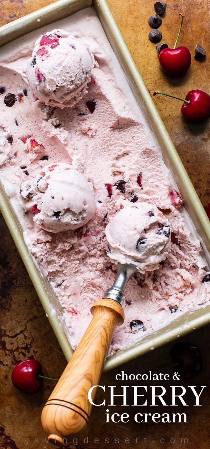 A baking pan filled with homemade fresh cherry ice cream with dark chocolate chips