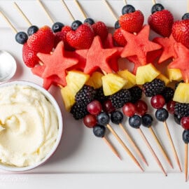 An overhead photo of a fruit platter with fruit dip on the side.