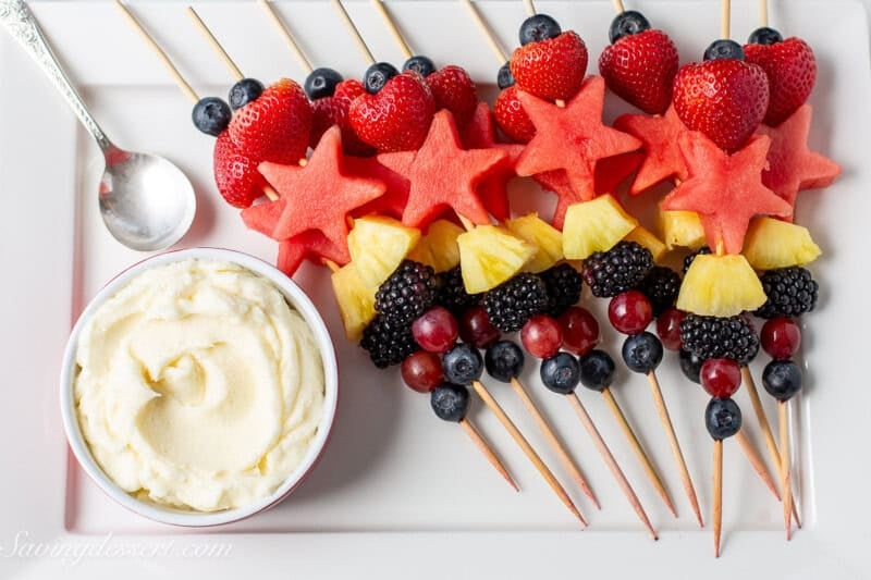 An overhead photo of a fruit platter with fruit dip on the side.