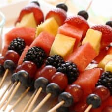 overhead shot of assorted fruit on kabobs