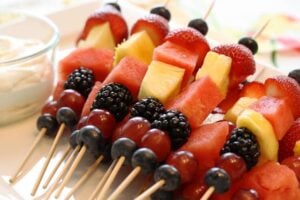 overhead shot of assorted fruit on kabobs