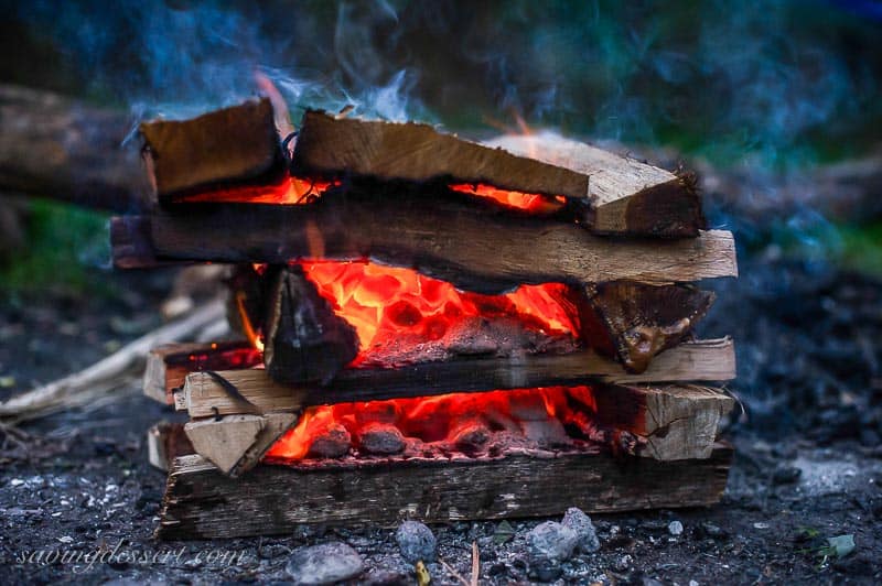 A camping fire with stacked logs