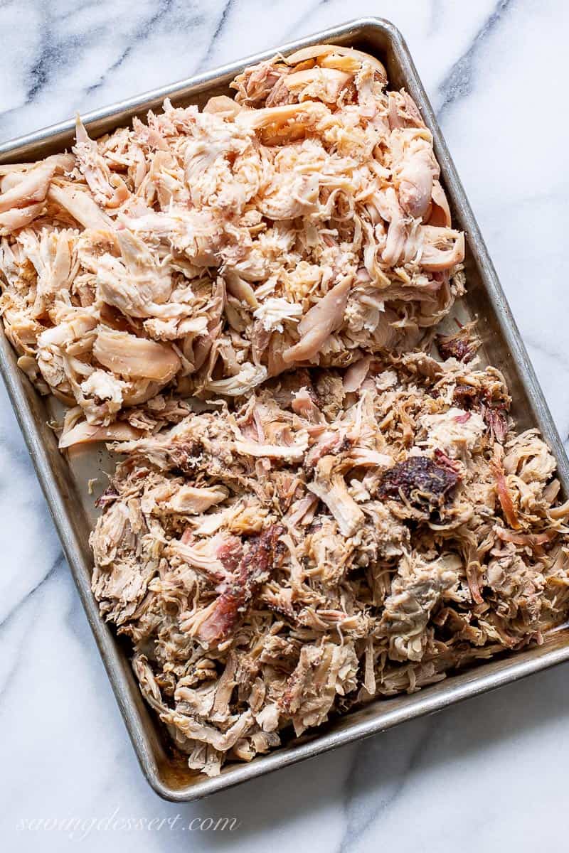 A baking tray filled with smoked shredded chicken and pork
