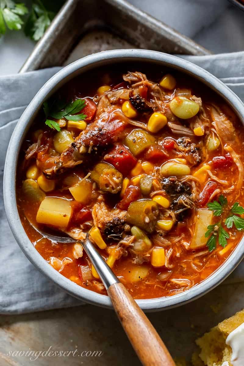 A bowl of Brunswick Stew with tomatoes, potatoes, okra and corn in a bowl