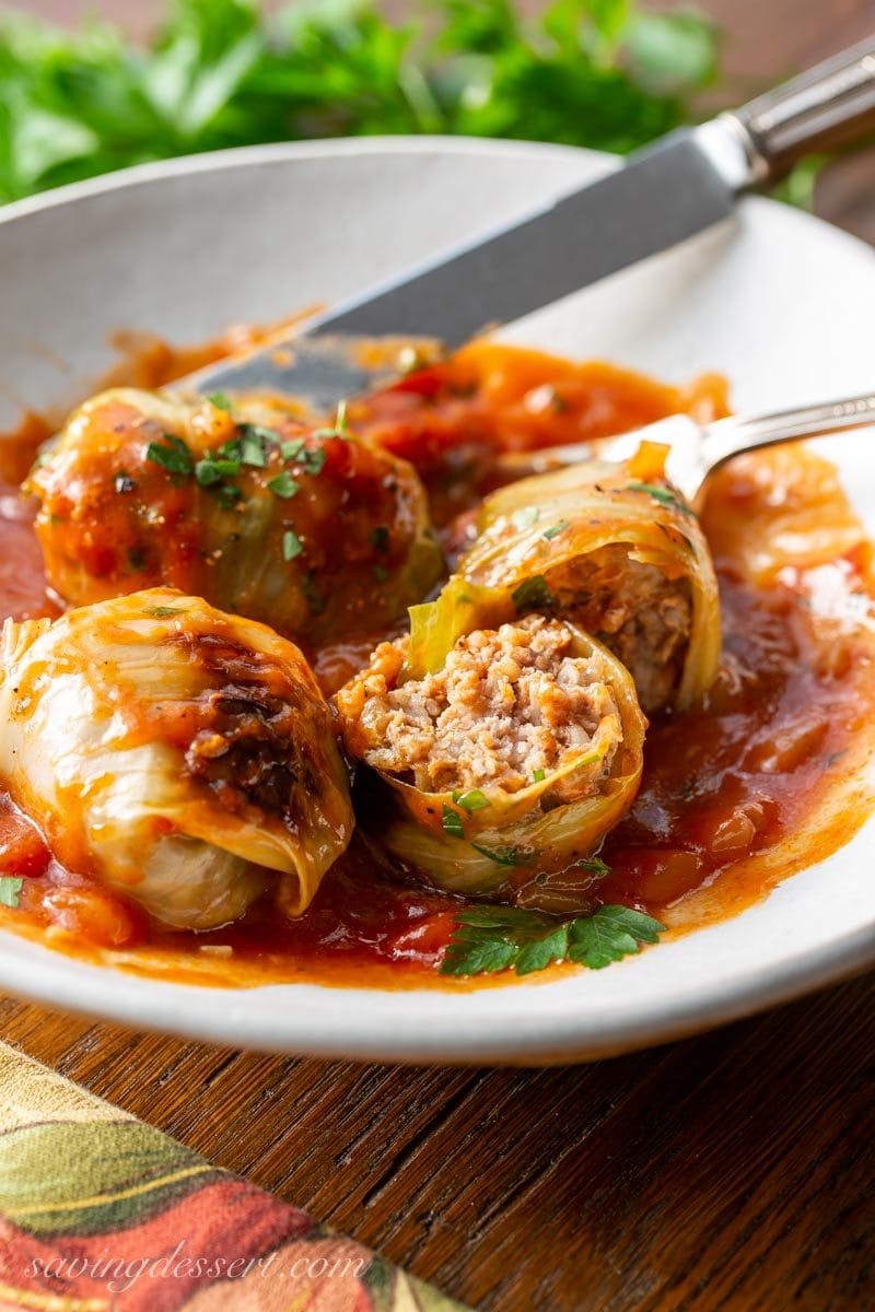 Cabbage rolls made with ground bee in a bowl with rich tomato sauce