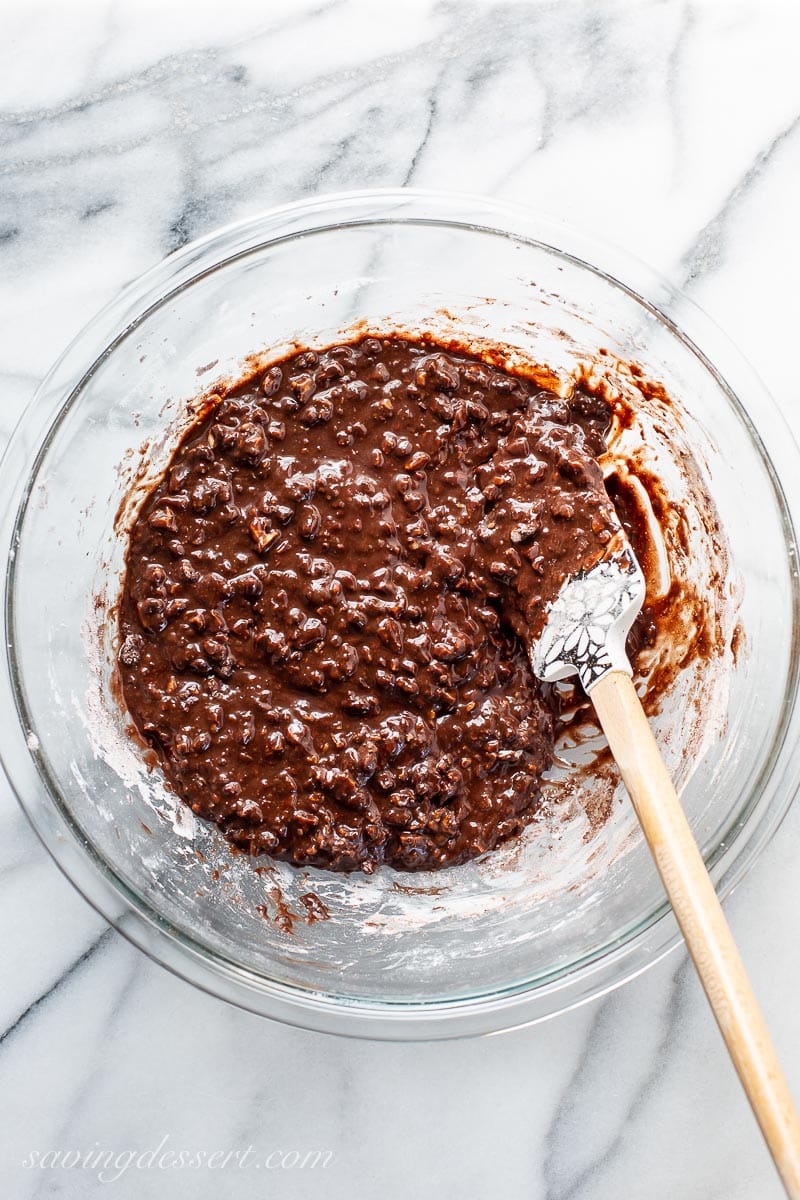 Chocolate cookie batter in a bowl with a spatula