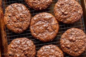 Overhead view of a cooling rack filled with chocolate cookies