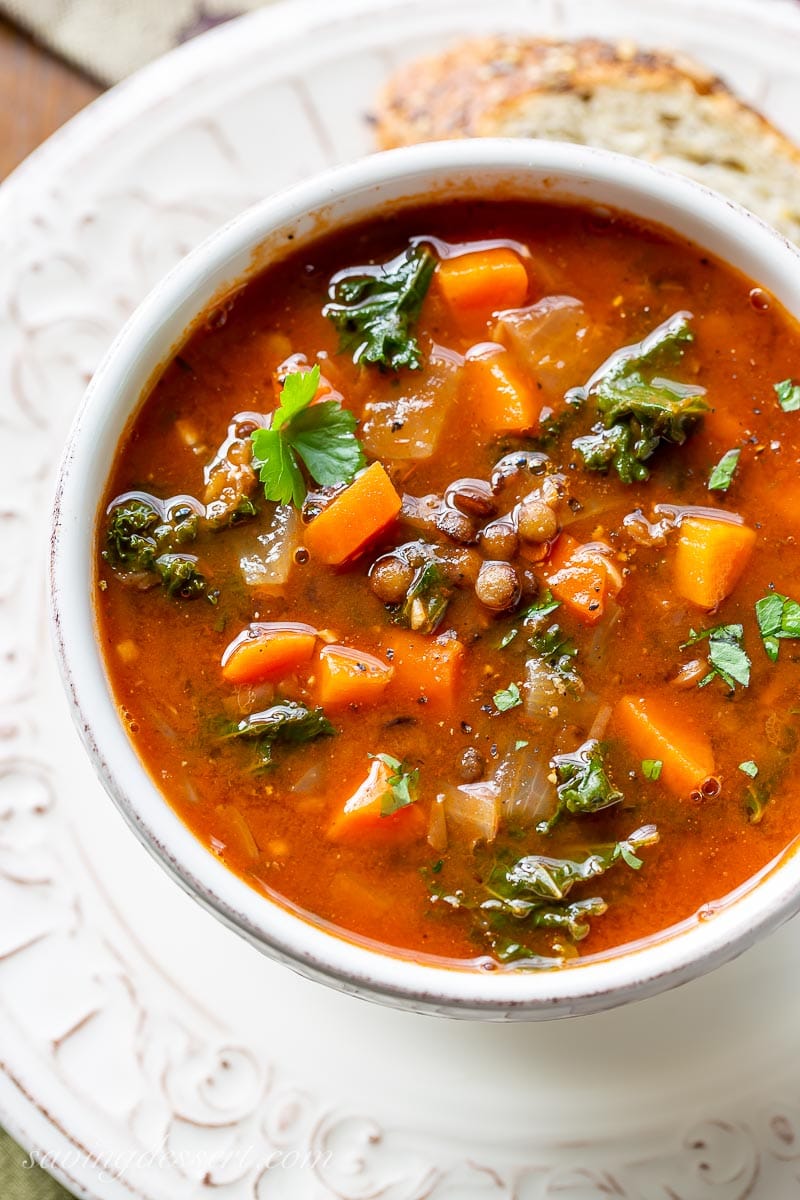 An overhead view of a bowl of vegetable and lentil soup