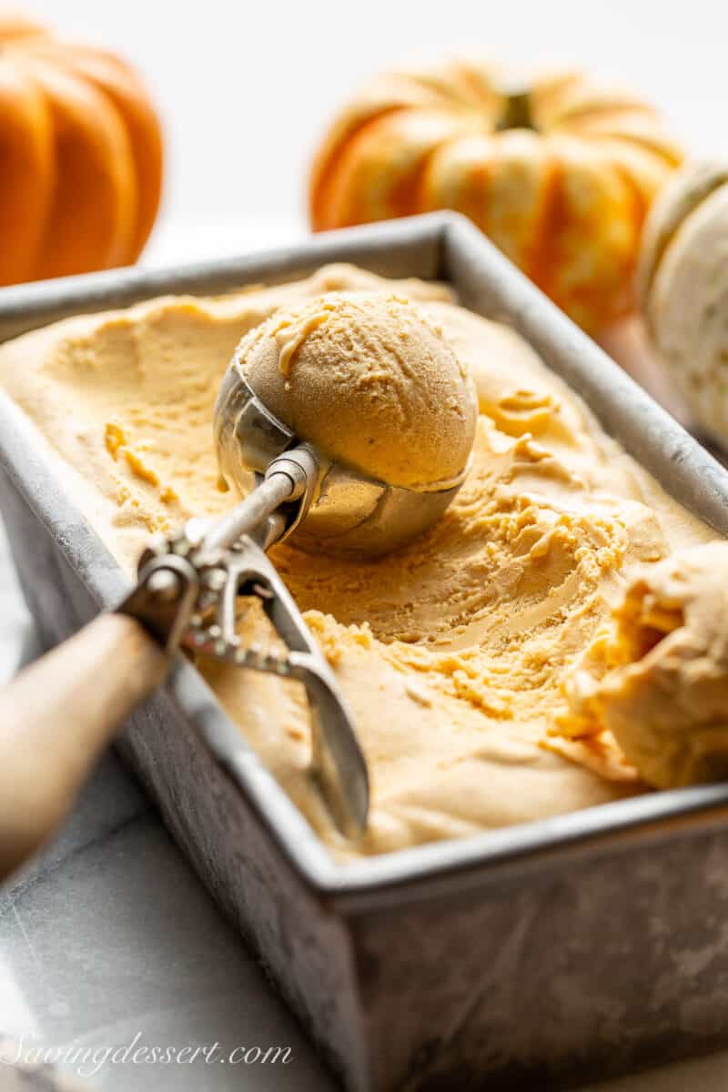 A scoop of pumpkin ice cream in a loaf pan.