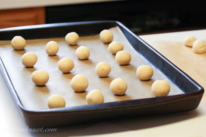 cookie dough balls on a baking sheet