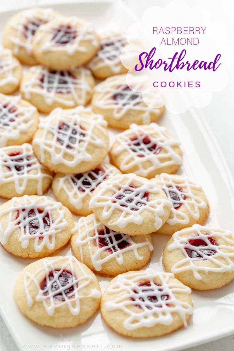 A plate of raspberry almond shortbread cookies drizzled with a simple icing