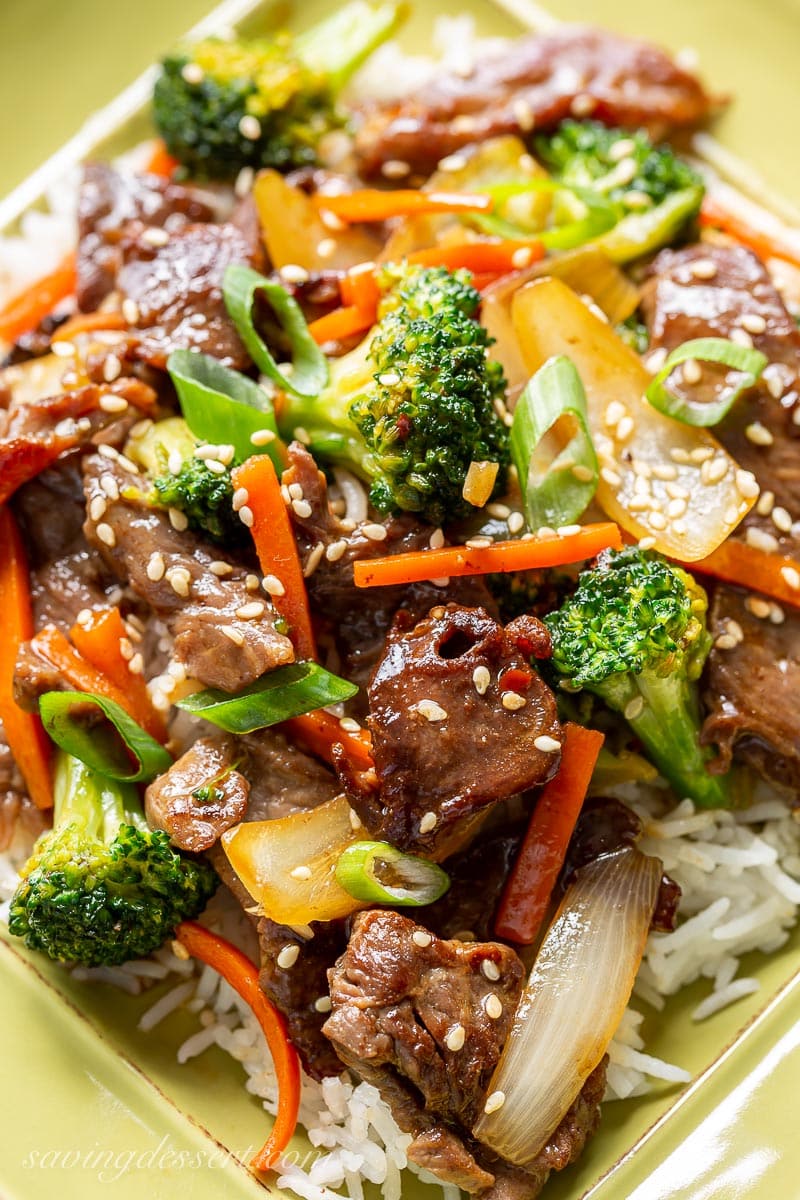 A close up of a plate of beef and broccoli over rice