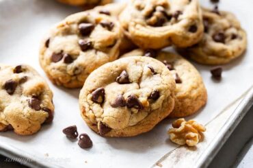 closeup of a stack of brown butter chocolate chip cookies with walnuts