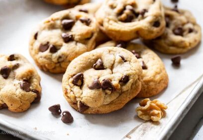 closeup of a stack of brown butter chocolate chip cookies with walnuts