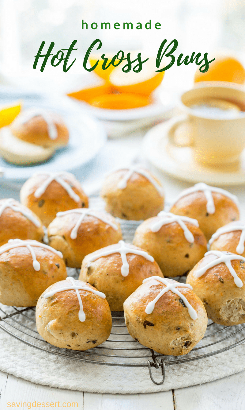 Hot Cross Buns - lightly sweet, orange scented yeast rolls with currants, raisins and plenty of warm spices. A traditional treat served during Lent and the Easter holidays. www.savingdessert.com #savingroomfordessert #hotcrossbuns #sweetbuns #buns #hotcross #easter #brunch #raisinrolls #holidaybaking