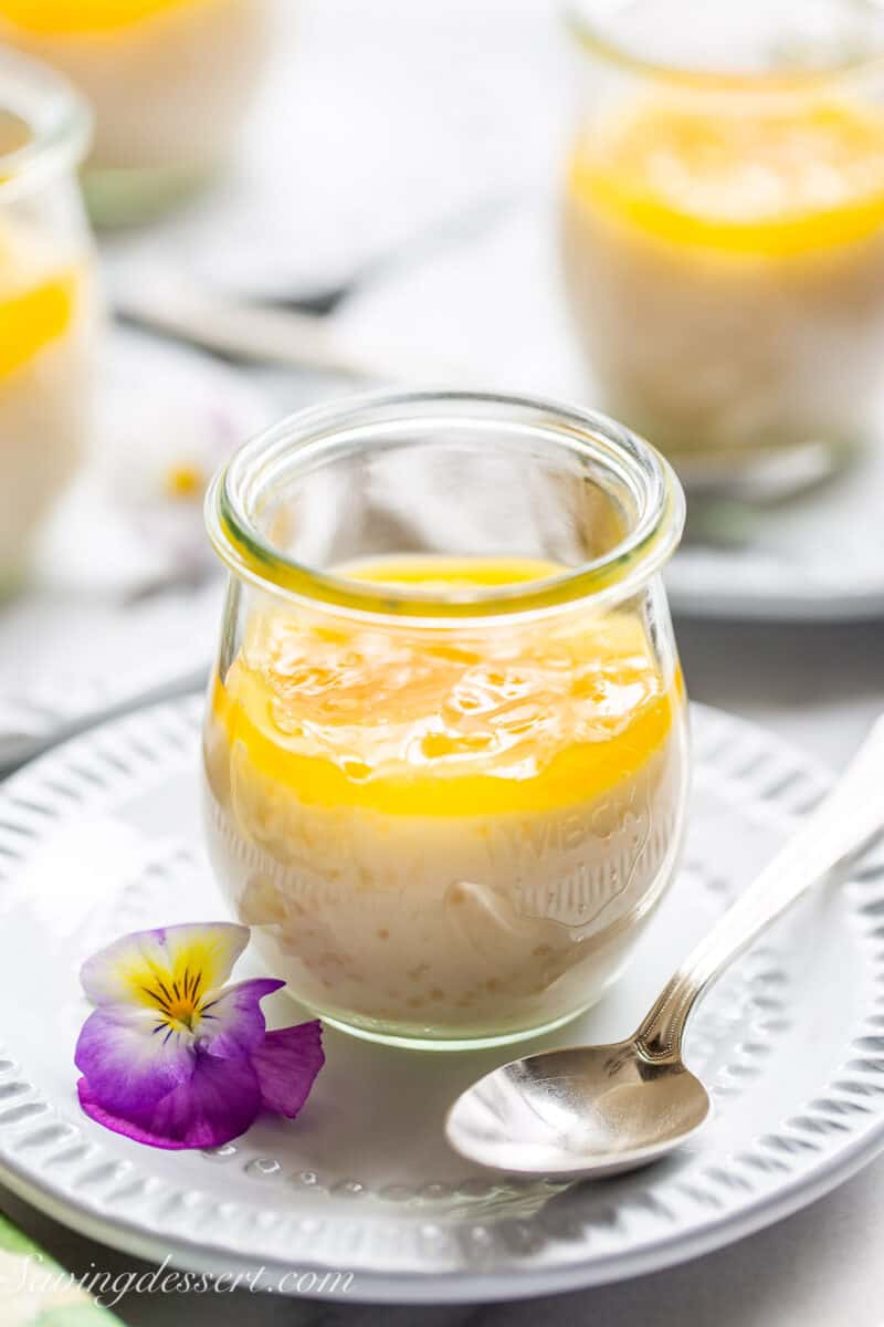 A jar of tapioca pudding with lemon curd on top.