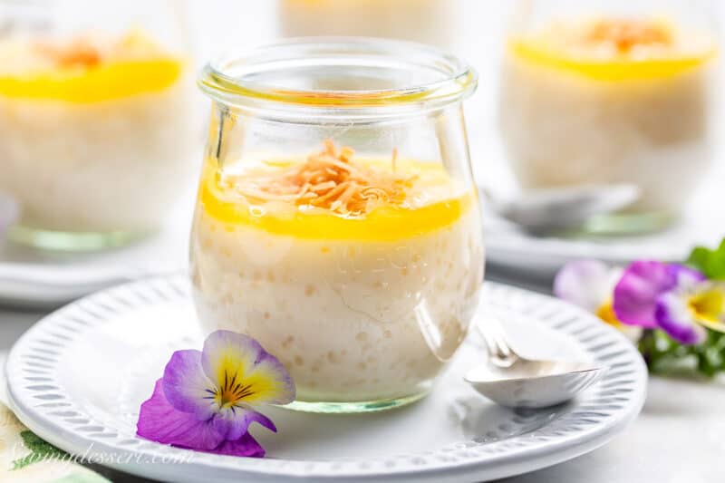 A few jars of coconut tapioca pudding topped with lemon curd and flakes of toasted coconut.