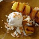 top view of pineapple slices with ice cream and sprinkled coconut