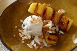 top view of pineapple slices with ice cream and sprinkled coconut