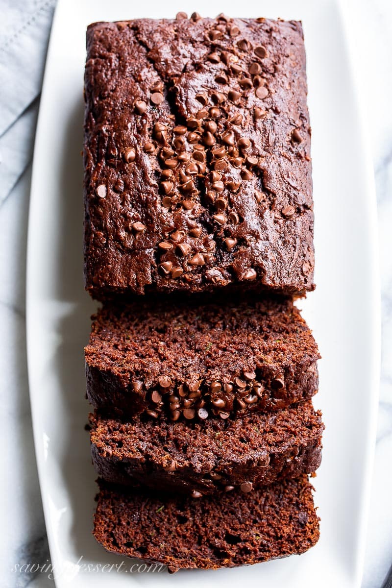 A sliced loaf of zucchini bread on a platter