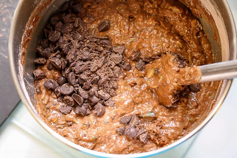 A bowl of chocolate cake batter with chocolate chips