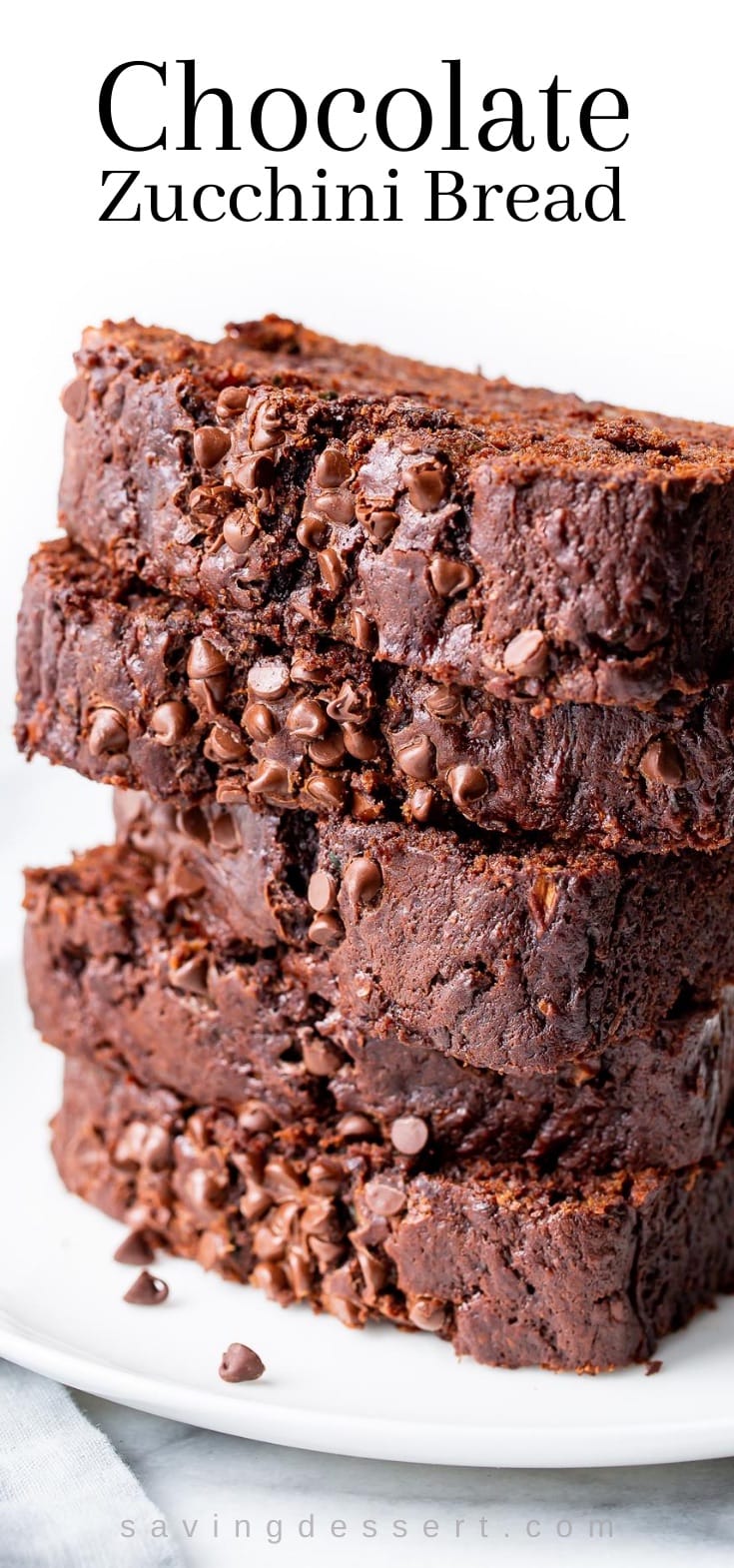 A stack of sliced chocolate zucchini bread with mini chocolate chips