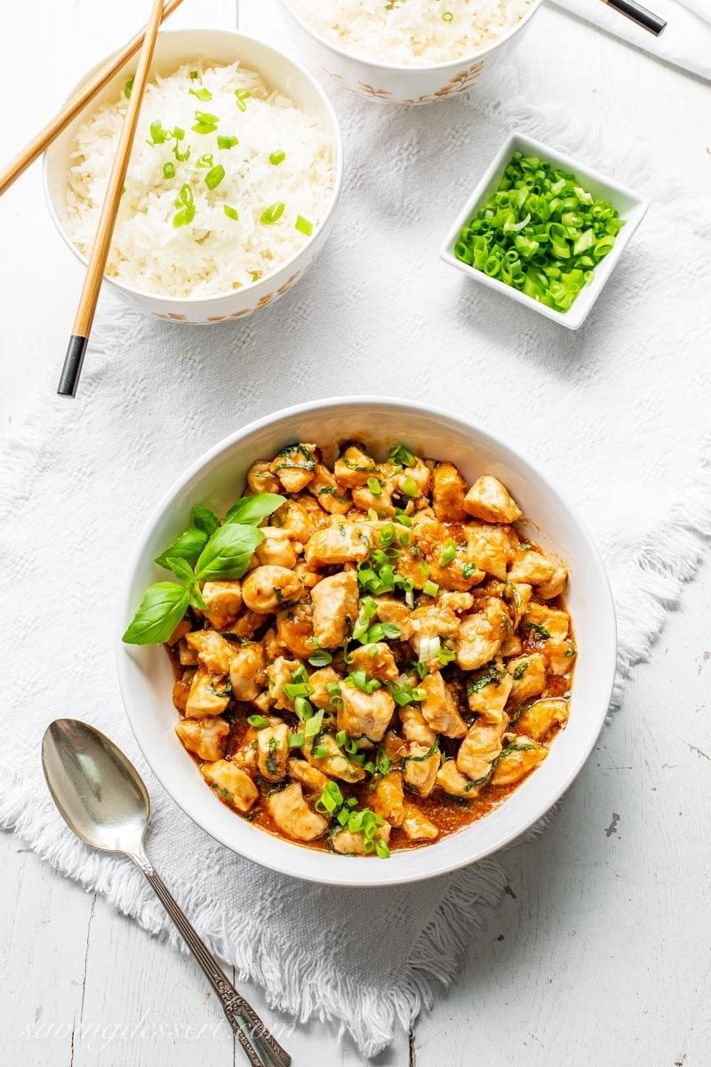 Spicy Basil Chicken with Jasmine rice and sliced green onions.