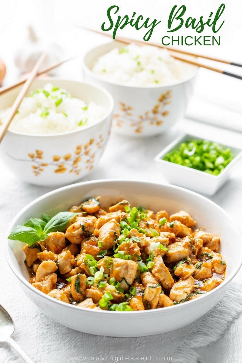 Spicy Basil Chicken Recipe - tender chunks of chicken sautéed in a well spiced sauce with plenty of fresh garlic, basil and minced shallots. This is a terrific chicken dish you'll want to put on repeat! #savingroomfordessert #chicken #spicybasilchicken #thaibasilchicken #basilchicken #asianchicken #easydinner
